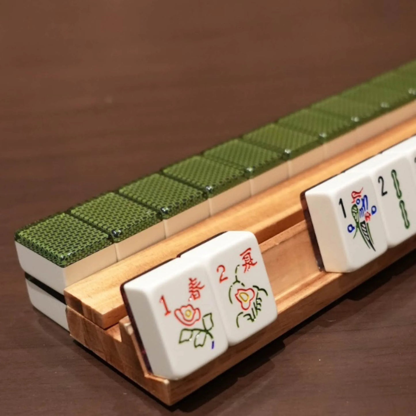 Chelsea green 36mm automatic mahjong tiles arranged on a wooden rack