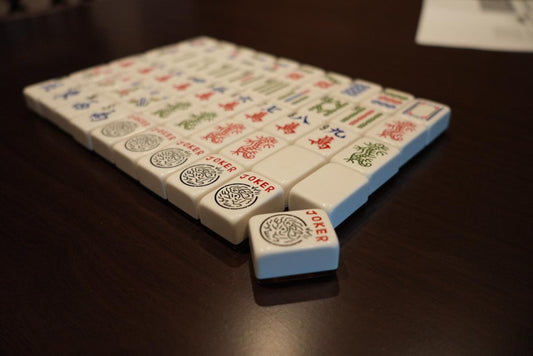 American Mah Jongg player holding a tile for a closer look