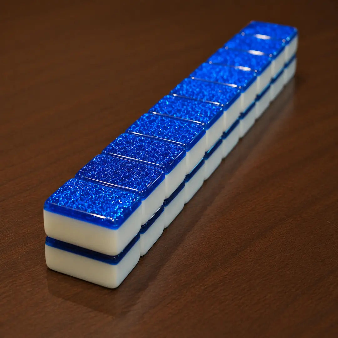 Row of blue and white rectangular objects on a wooden surface