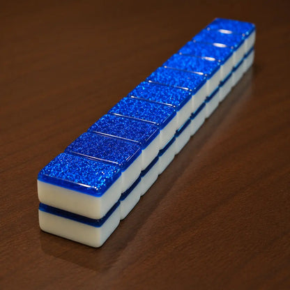 Row of blue and white rectangular objects on a wooden surface
