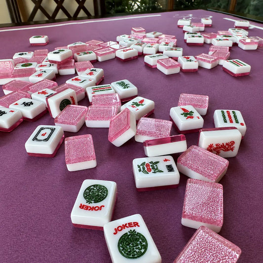 Pink Sparkling Mahjong tiles on a purple table with 'Joker' tiles included.