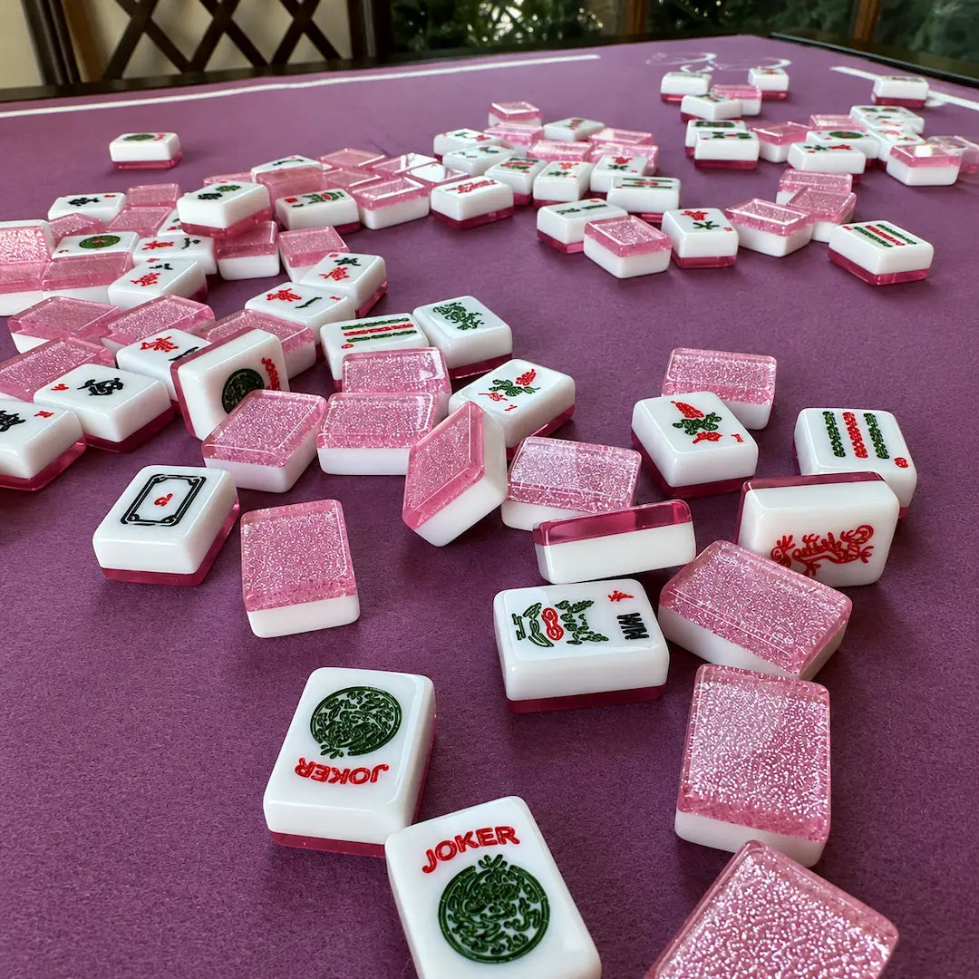 Pink Sparkling Mahjong tiles on a purple table with 'Joker' tiles included.
