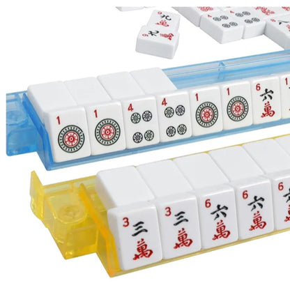 Close-up of white engraved American mahjong tiles arranged in blue and yellow all in one rack and pusher sets
