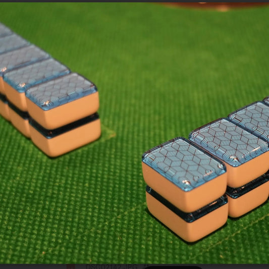 Two walls of 36mm blue deco weave automatic mah jongg tiles set up for play on a green mat.