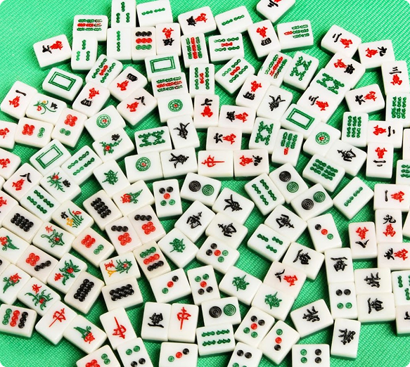 Collection of Mahjong tiles on a green background