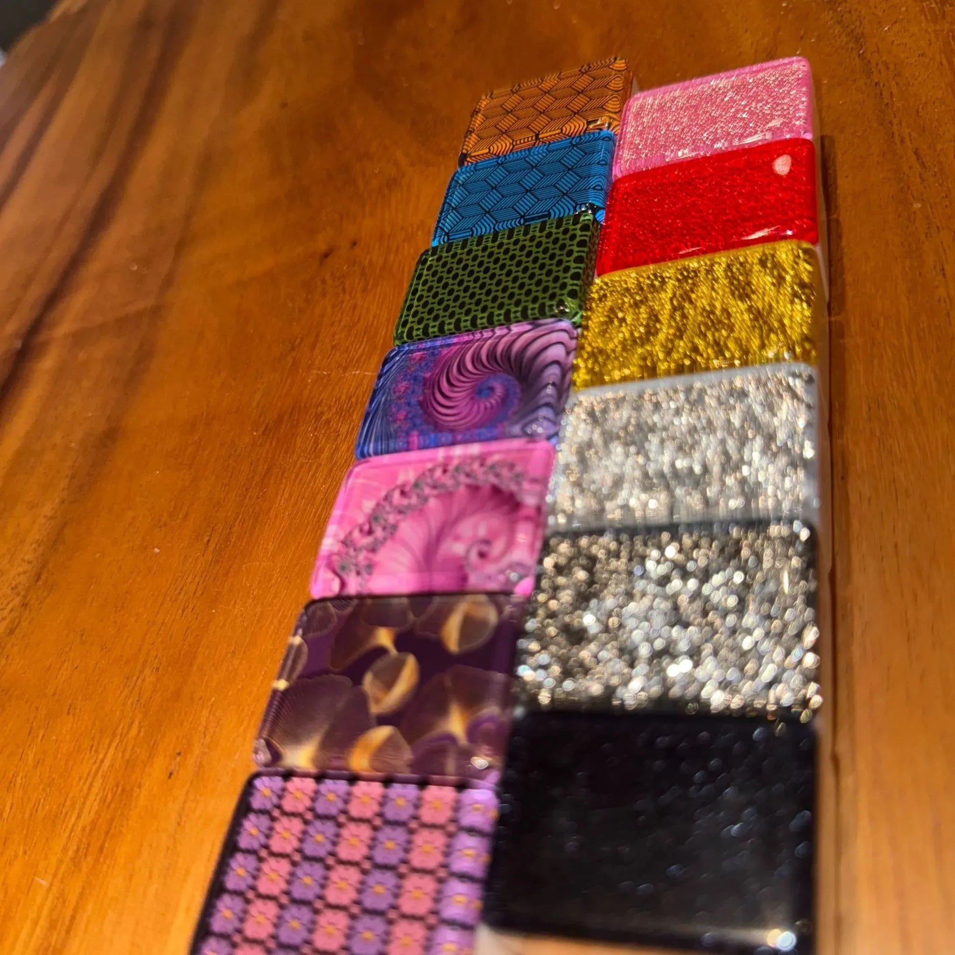 Collection of designer series automatic mah jongg tile finishes showing various patterns including deco weave and glitter styles.