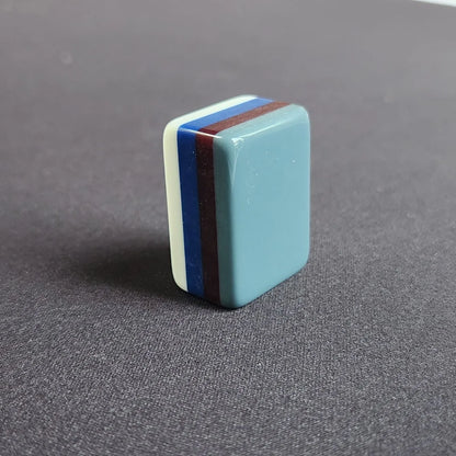 Side profile of Earl Grey 30MM American mah jongg tile with layered gray, white, blue, and red edges
