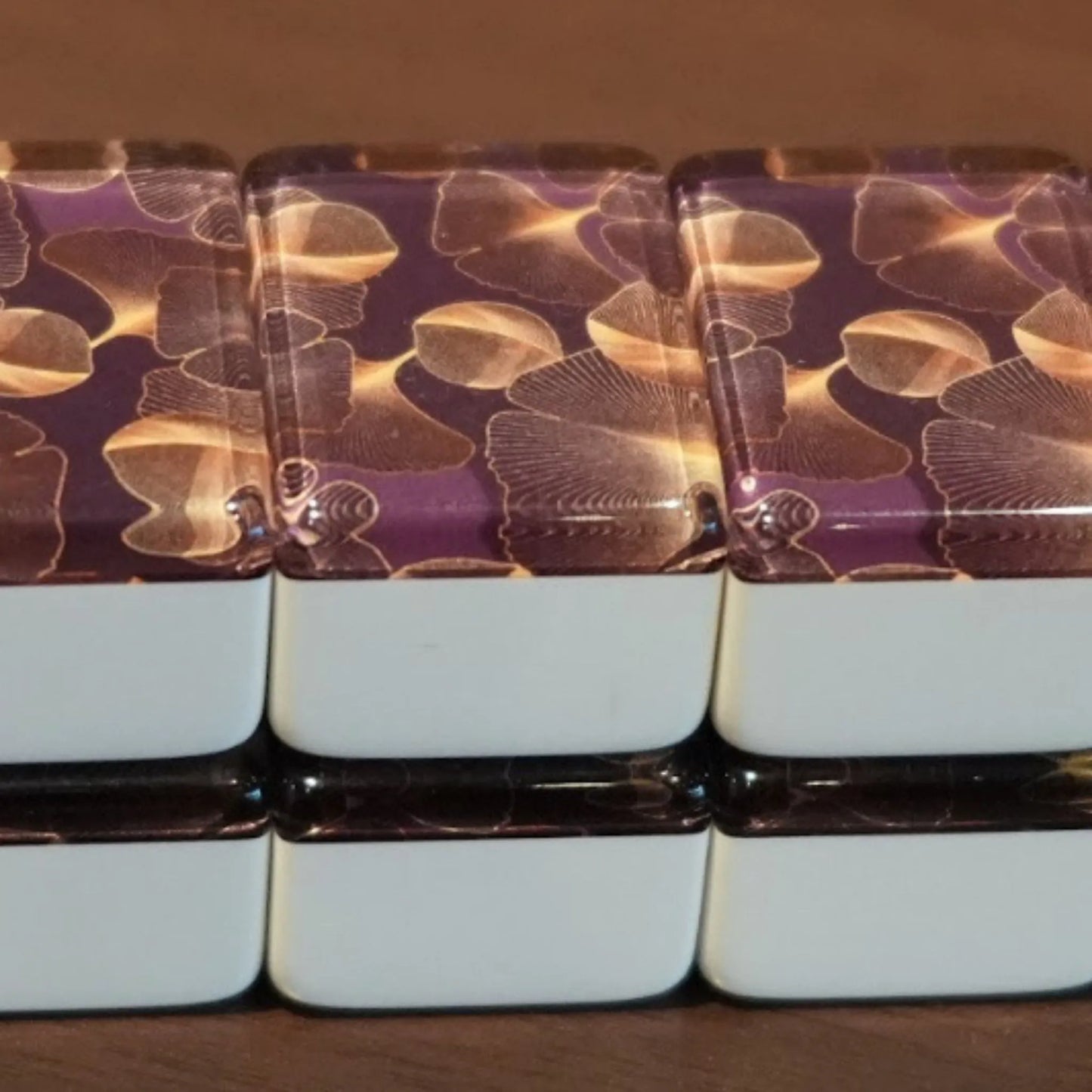 Front view of a double-stacked wall of 36mm gingo automatic mah jongg tiles showing the repeating leaf pattern.