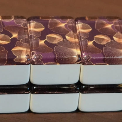Front view of a double-stacked wall of 36mm gingo automatic mah jongg tiles showing the repeating leaf pattern.