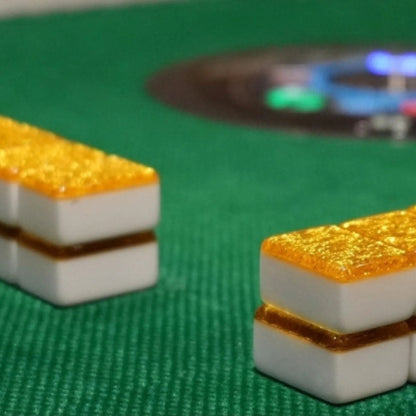 Gold sparkle 36mm automatic mahjong tiles placed on green automatic mahjong table felt
