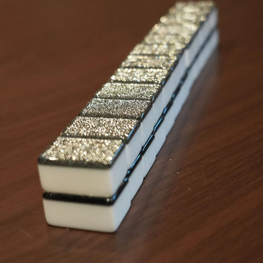 Stacked row of gray sparkle 36mm automatic mahjong tiles with glitter faces

