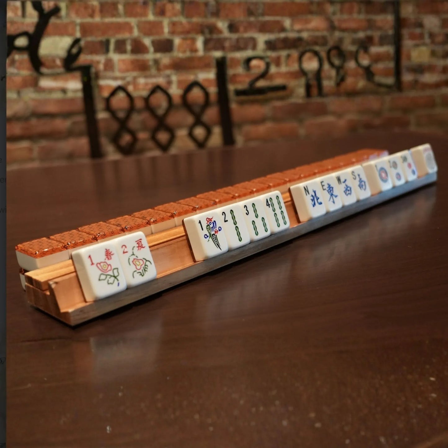 Metropolitan copper 36mm automatic mahjong tiles arranged on a wooden rack
