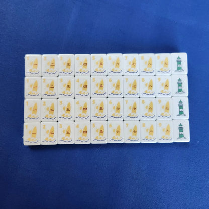 A set of Chinese mahjong tiles arranged in a grid on a solid blue background. The tiles are white with gold-colored Chinese characters and symbols, and two tiles feature green illustrations of pagoda-like structures.