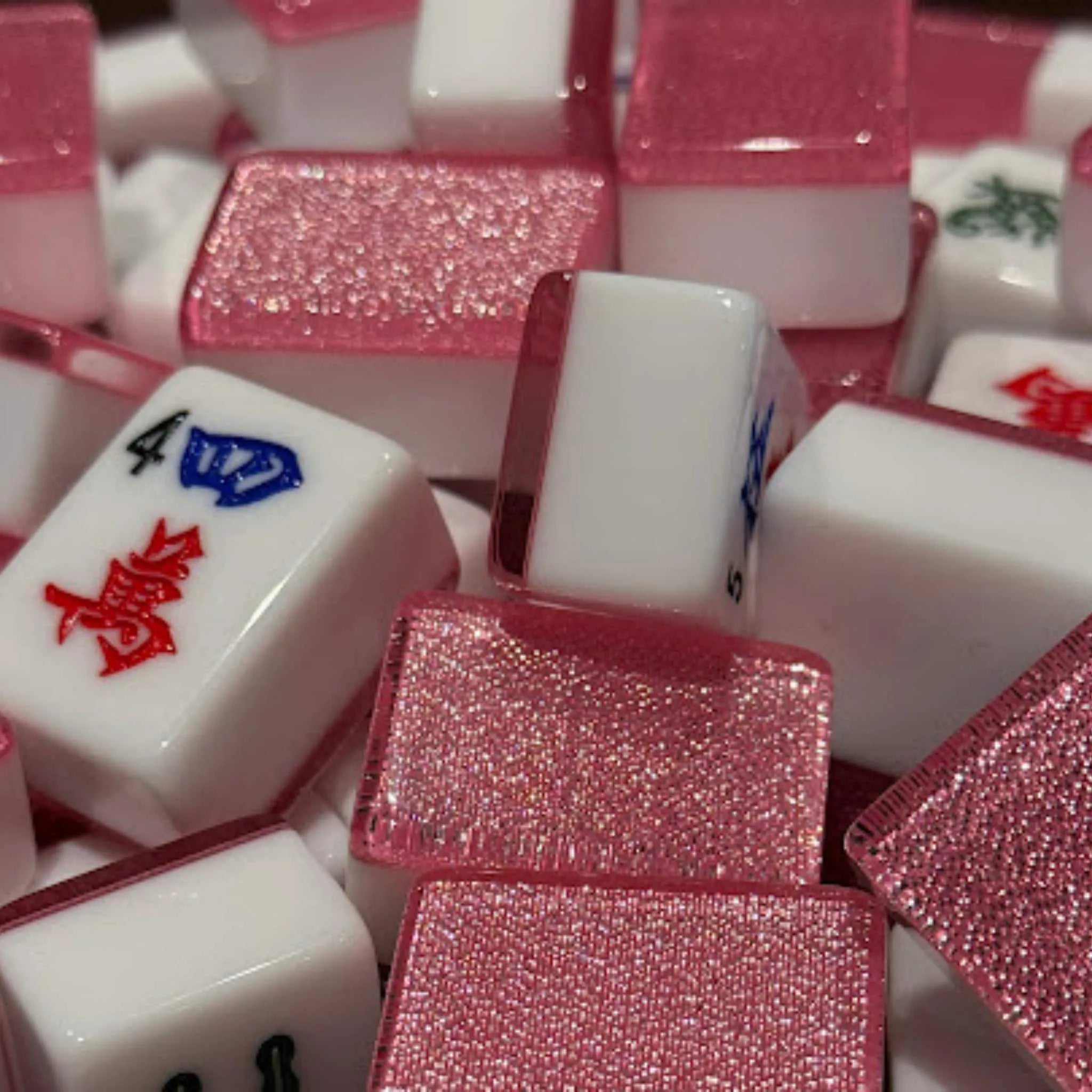 Close-up of pink sparkle 36mm automatic Mah Jongg tiles with glitter finish