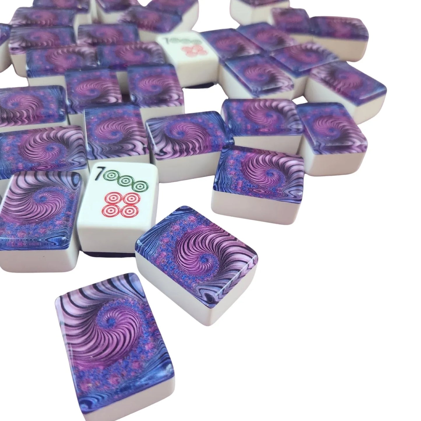 A pile of Mahjong tiles with a purple and blue psychedelic spiral pattern on a clean white background.