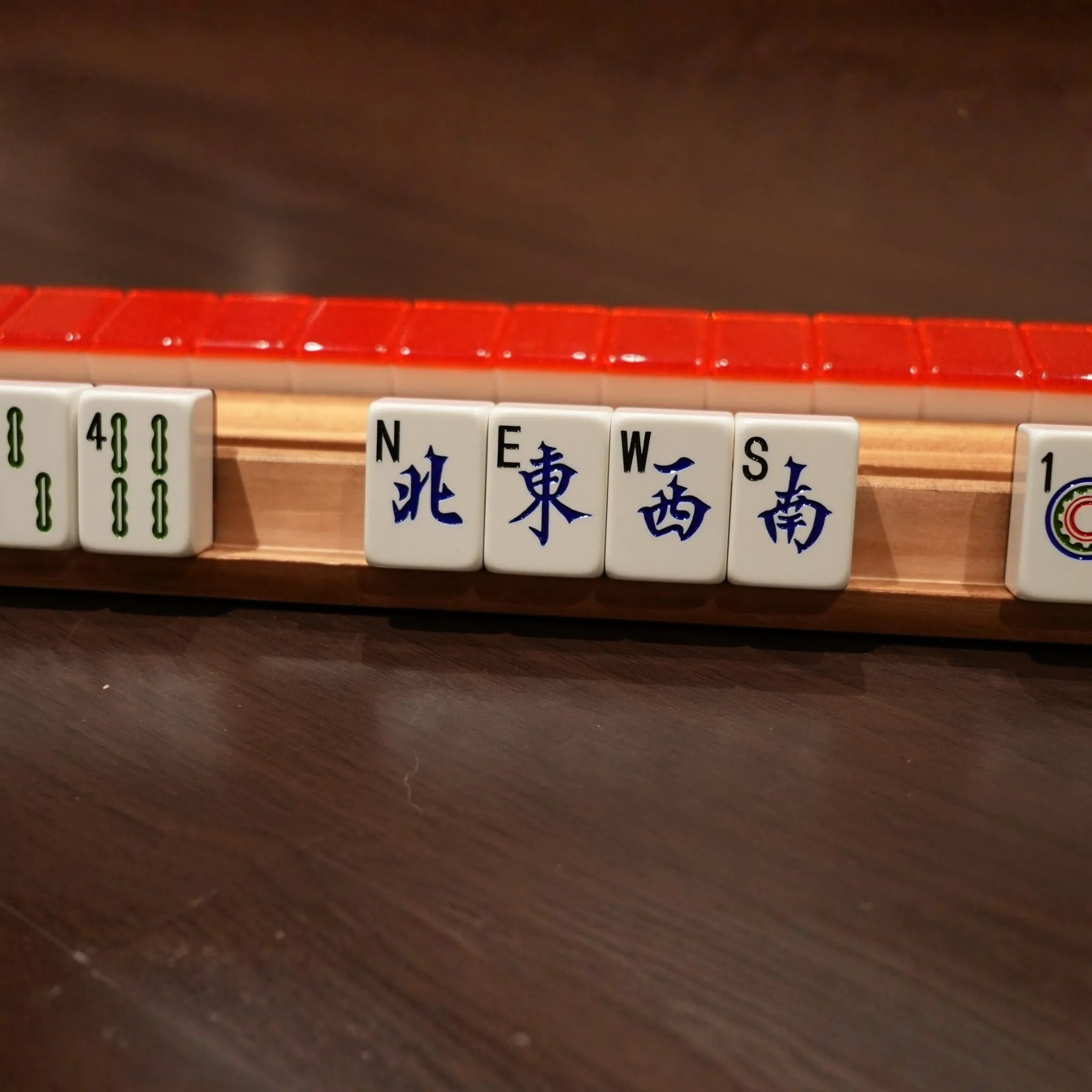 Red Sparkle 36MM automatic Mah Jongg wind tiles displayed on a rack