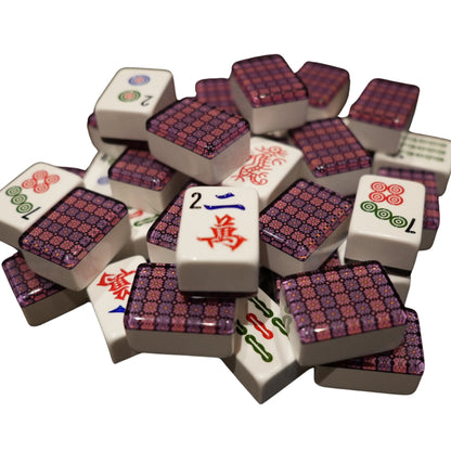 Stack of assorted mahjong tiles on a white background