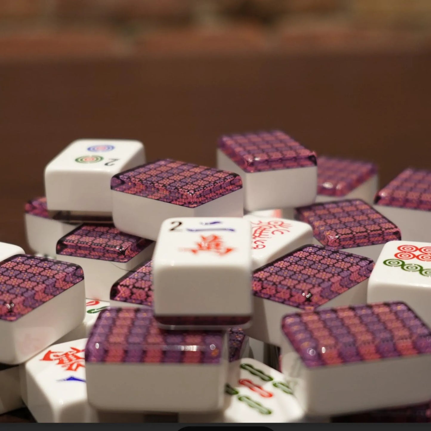 Close-up of violet mosaic 36mm automatic mahjong tiles showing geometric patterned faces

