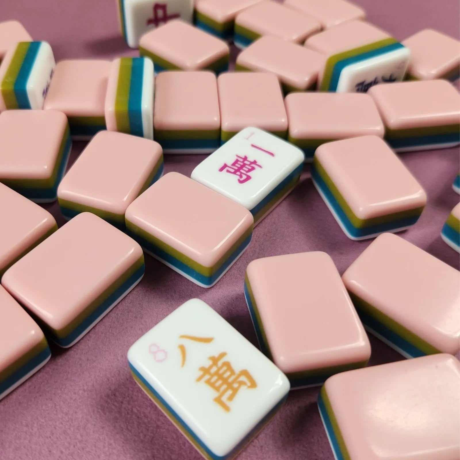Watermelon 30MM American Mah Jongg tiles displayed in rows on a pink table surface