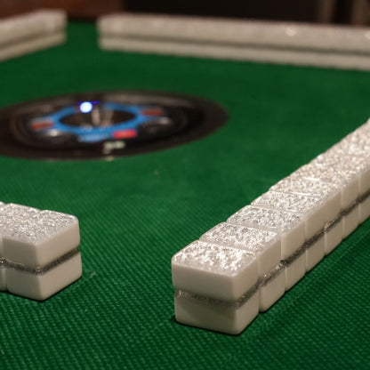 white Mahjong tiles with silver glittery accents.