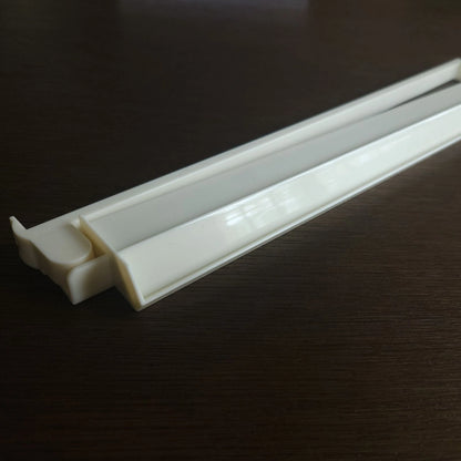 White plastic strip on a dark surface
